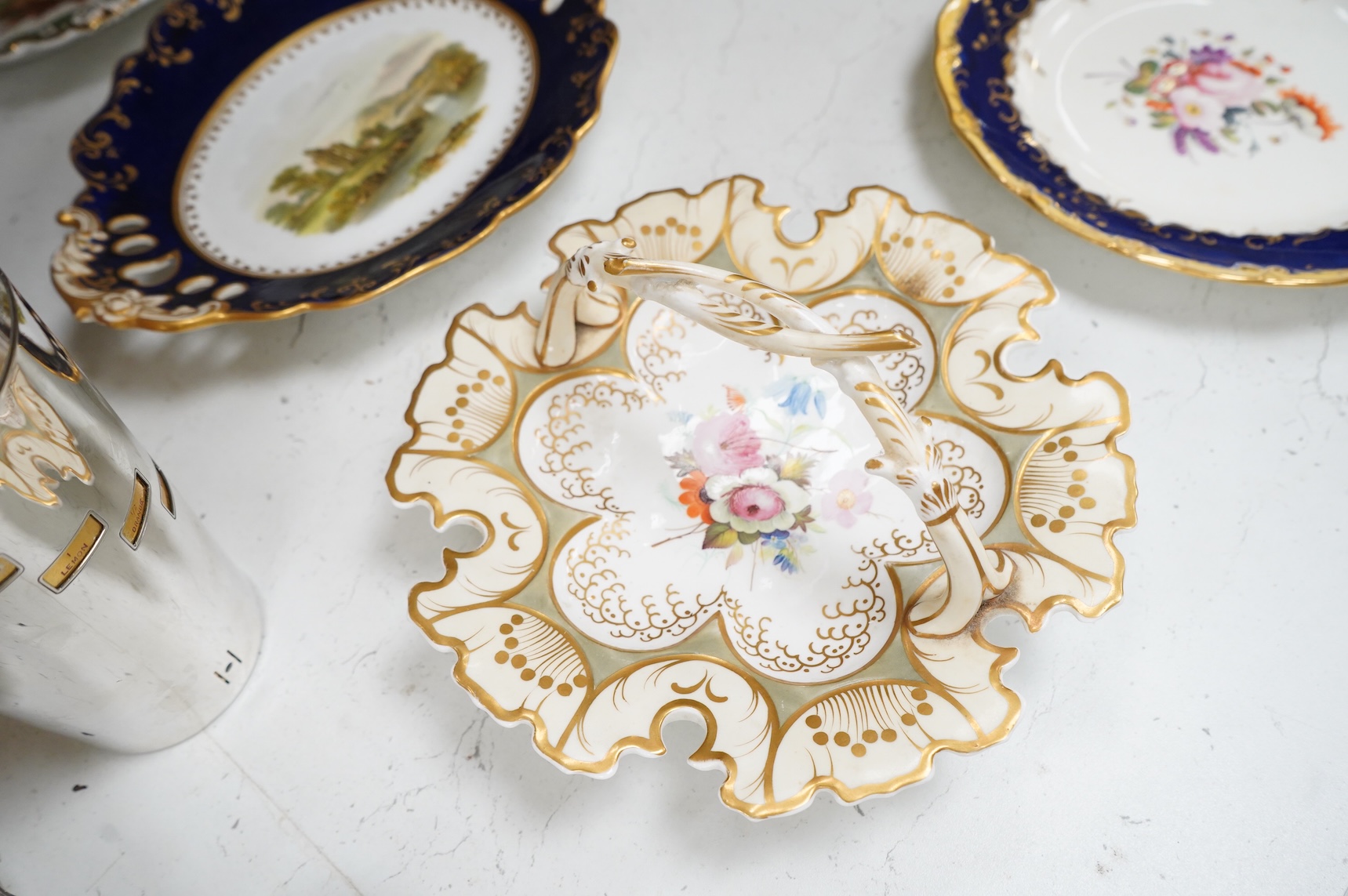 A collection of 19th century English dessert wares to include a pair of Flight, Barr and Barr ‘fantastic birds’ green ground dessert plates, various Ridgway dessert plates, five Minton botanical plates with tooled gilt b